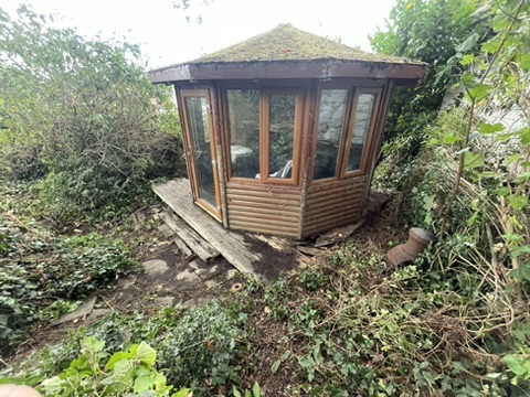 Wooden summer house brought back into daylight